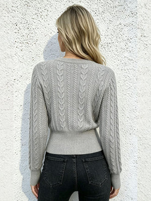 Blue crewneck sweater featuring cable-knit and cable knit