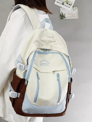 Chic color block nylon backpack with brown sides and blue accents, featuring adjustable straps.