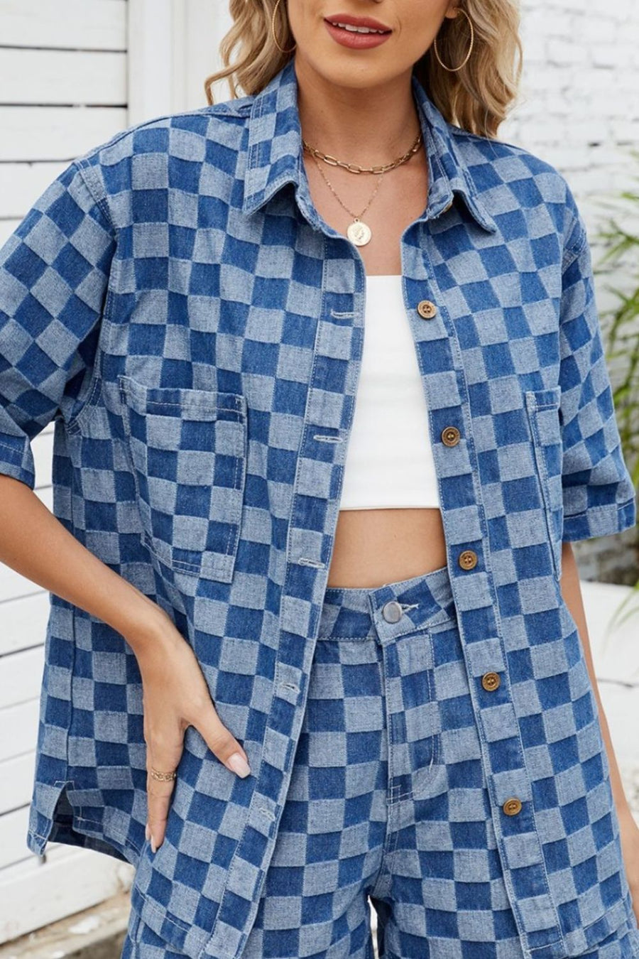 Boxy denim shirt in medium blue checkered pattern with button front and chest pockets.