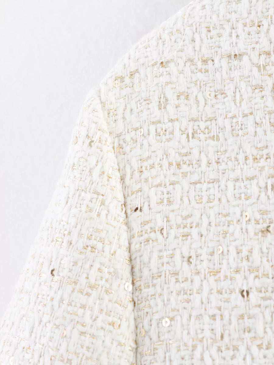 White tweed cropped jacket with gold sequins and button-up detail.