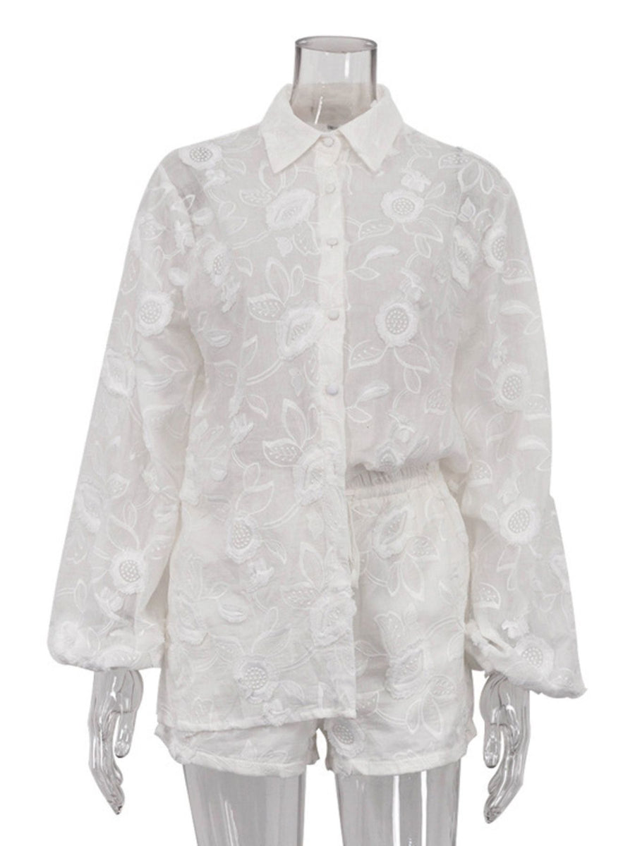 White embroidered two-piece shirt and shorts set with button-down shirt and elastic waist shorts.