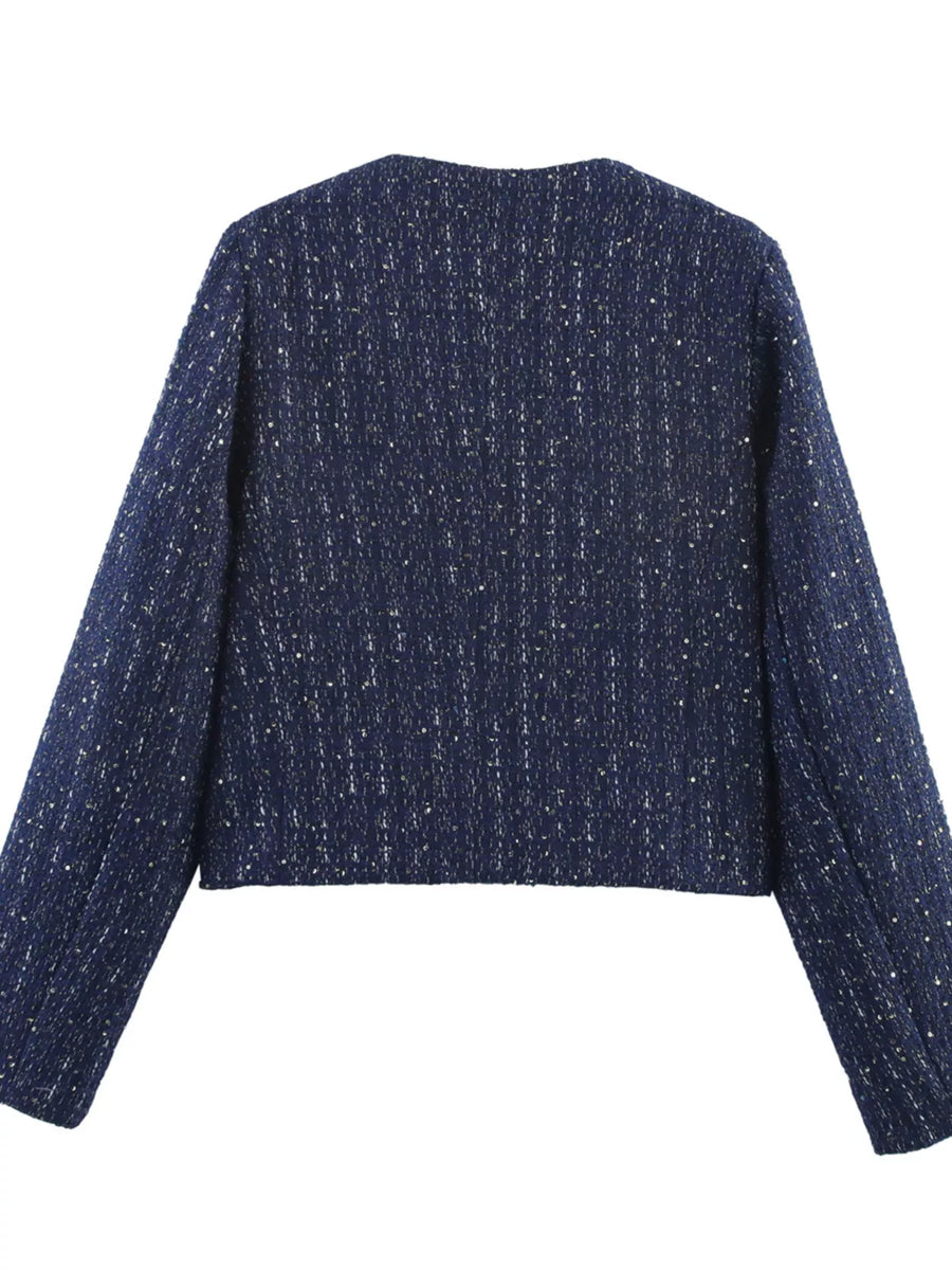 Dark blue cropped tweed jacket with metallic threads and a round neckline.