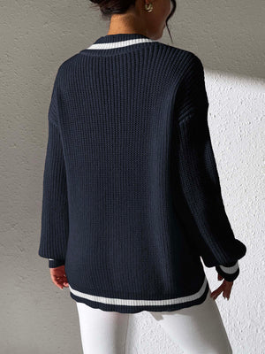 Dark navy knit sweater with white stripe trim at V-neck and hem.