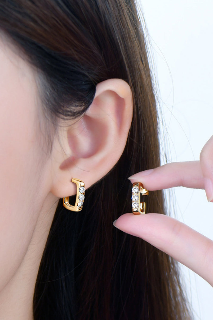 Gold square pavé moissanite hoop earrings with clear stones.