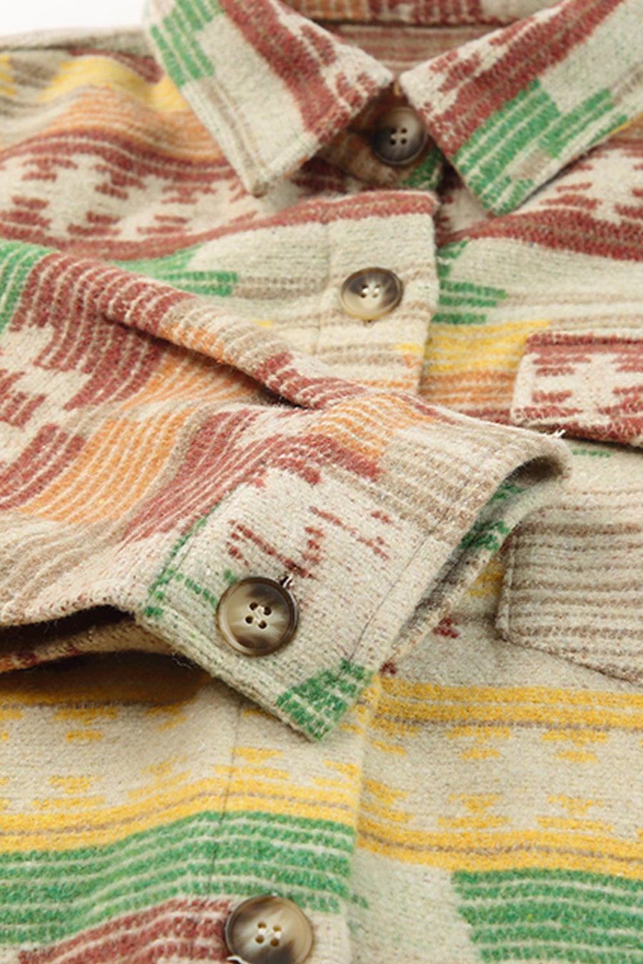 Shacket with Aztec print, button front, and patch pockets in tan with red, green, and yellow stripes.