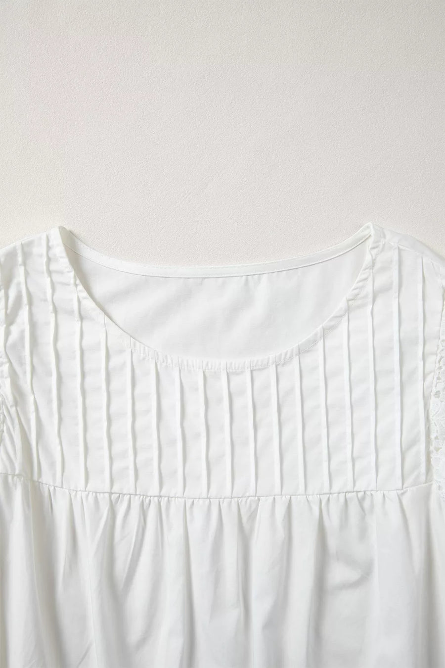 White cotton shirt with lace flutter sleeves and pleated front detail
