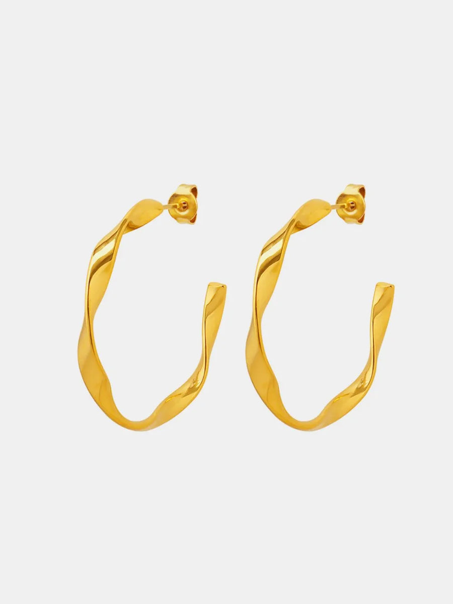 Gold twisted hoop earrings with a sculpted design.
