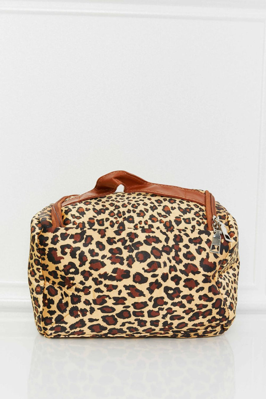 Leopard print travel organizer bag with brown trim and handle.