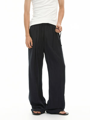 wide-leg pants in light beige with drawstring waist and full-length
