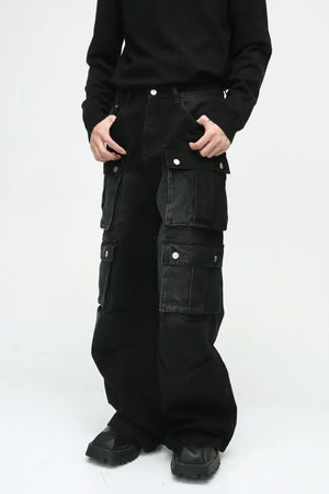 Dark cotton wide-leg cargo pants with multiple utility pockets and silver snap closures.
