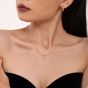 cream necklace featuring layered and star