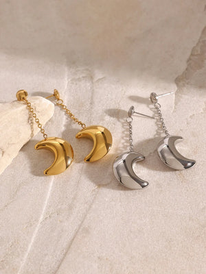 Celestial crescent drop earrings in gold and silver with chain detail.