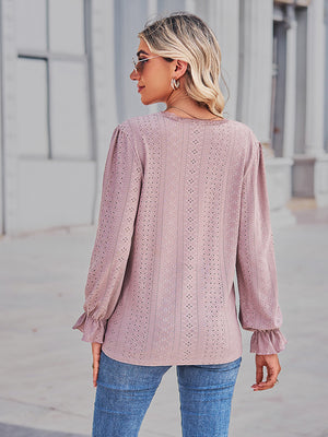 Blush pink lace-cut prairie blouse with ruffled sleeves and eyelet pattern.