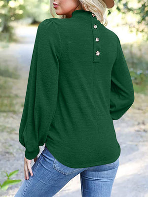Dark green mock neck top with puff sleeves and button back detail