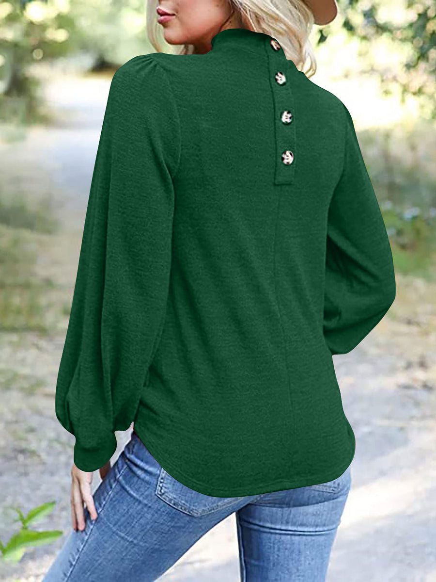 Dark green mock neck top with puff sleeves and button back detail