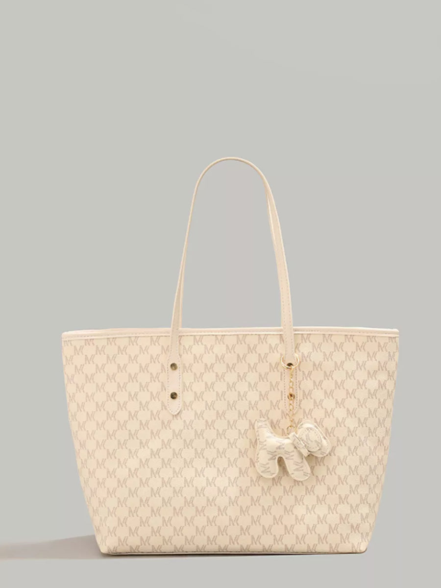 Ivory monogrammed tote bag with dog charm accessory