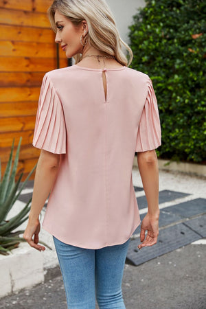Blush pink blouse with pleated short sleeves and keyhole back detail.