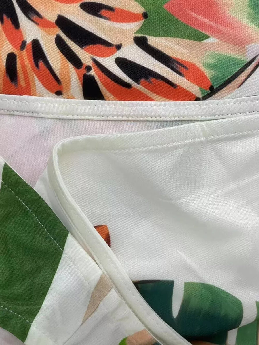Tropical print maxi dress with white trim and green leaf detail.