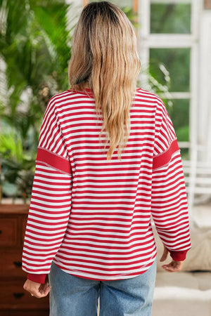 white sweatshirt featuring contrast stitching and striped