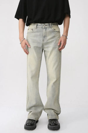 Vintage wash flare denim trousers in light blue with a relaxed fit and subtle fading.