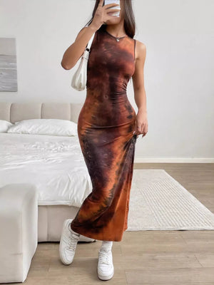 Vibrant tie-dye maxi dress with a sleeveless, high-neck design in brown and orange hues.