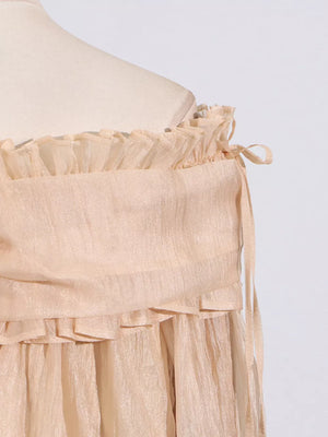 Romantic off-shoulder ruffled blouse in champagne color with tie details.