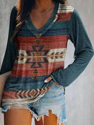 Geometric v-neck long sleeve t-shirt with red, blue, and cream tribal print on front, solid teal sleeves.