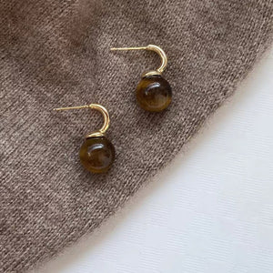 earrings in brown featuring ball drop and drop fit
