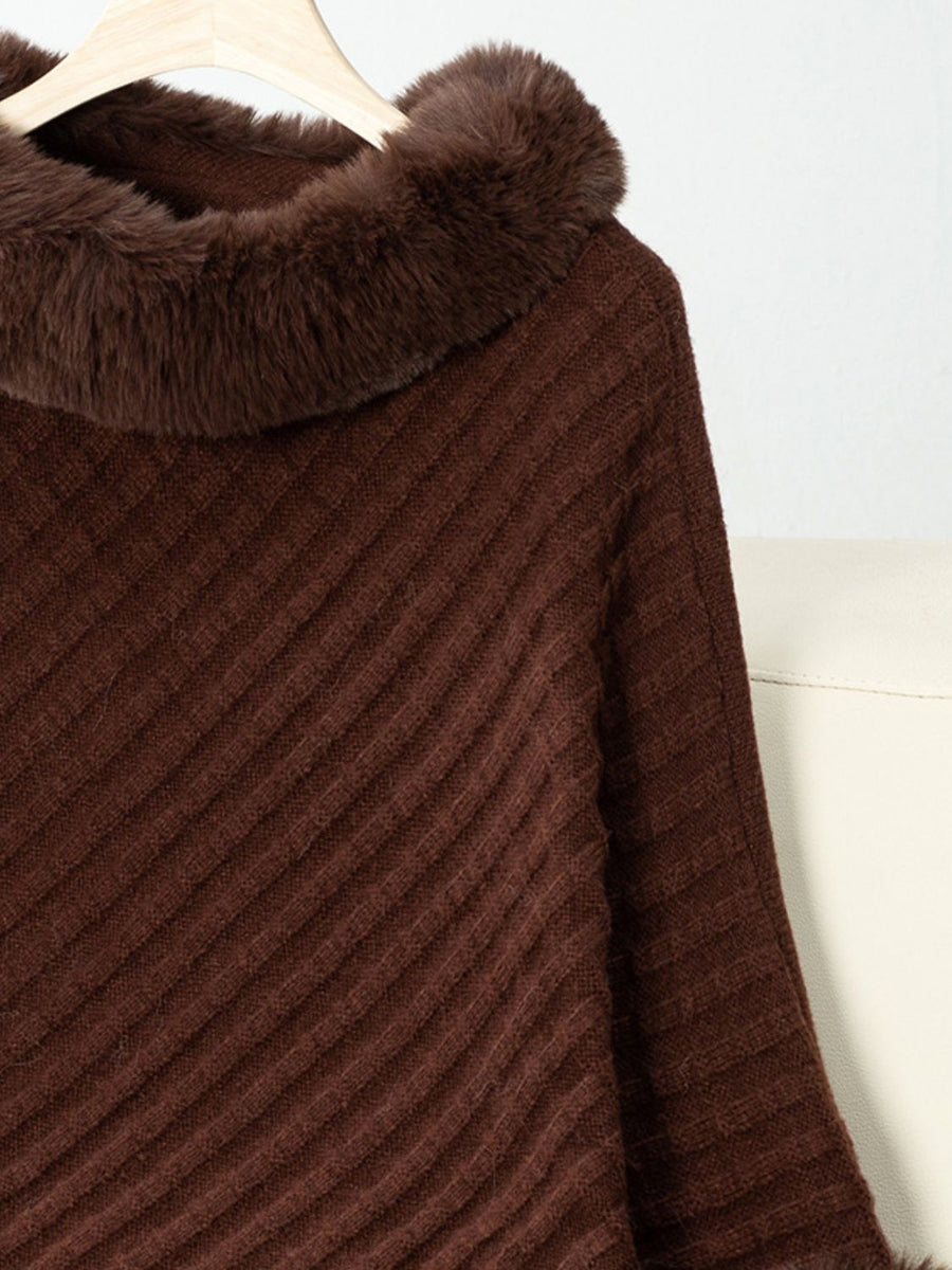 Chocolate knit poncho with faux fur trim and diagonal ribbing detail.