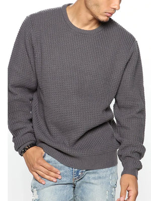 Dark gray waffle knit crewneck sweater with relaxed fit and ribbed cuffs.
