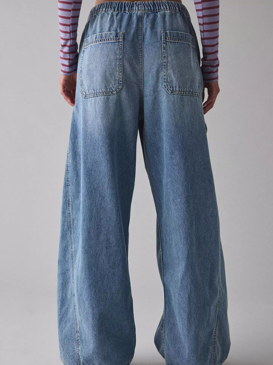 Drawstring waist cargo jeans in dusty blue denim with wide legs and back pockets.
