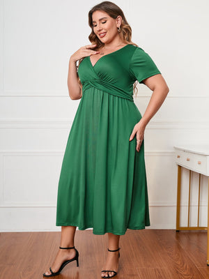 Emerald twist-front midi dress in dark green with short sleeves and a V-neck.