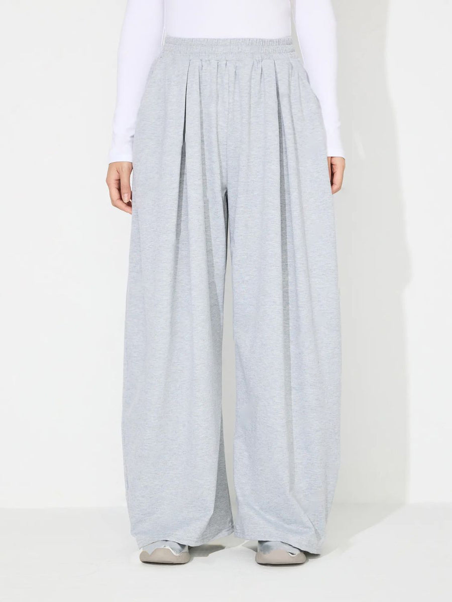 Light gray pleated drape palazzo trousers with elastic waistband.