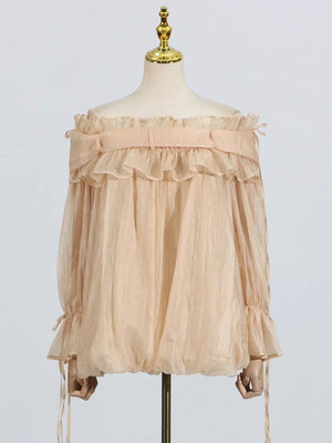 Romantic off-shoulder ruffled blouse in champagne color with billowy sleeves and adjustable ties.