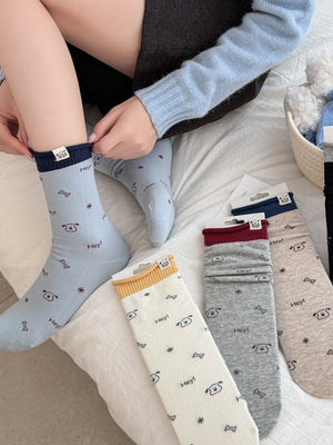 beige socks featuring ribbed cuff and cartoon-print
