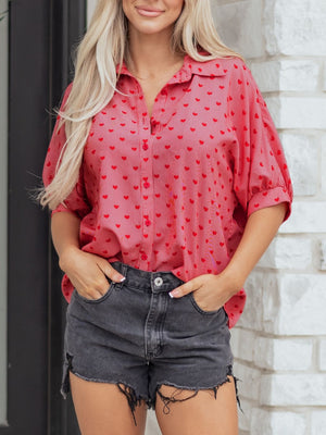 Red heart patterned button-down shirt with cuffed sleeves and classic collar.