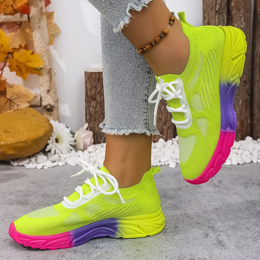 Fluorescent green lace-up sneakers with a pink and purple ombre sole.