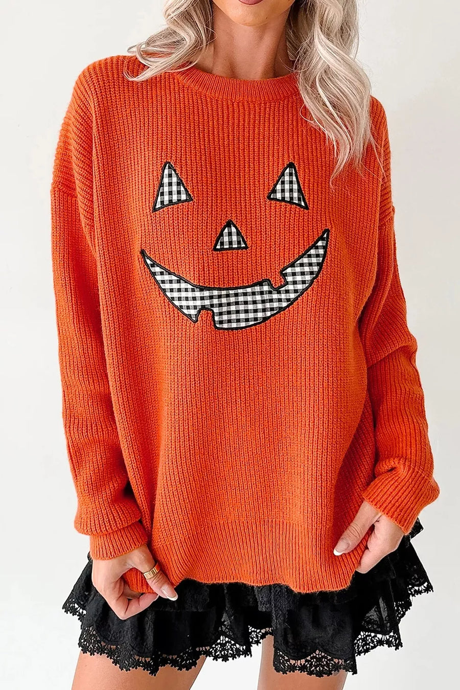 Orange pullover sweater featuring drop shoulder and graphic print