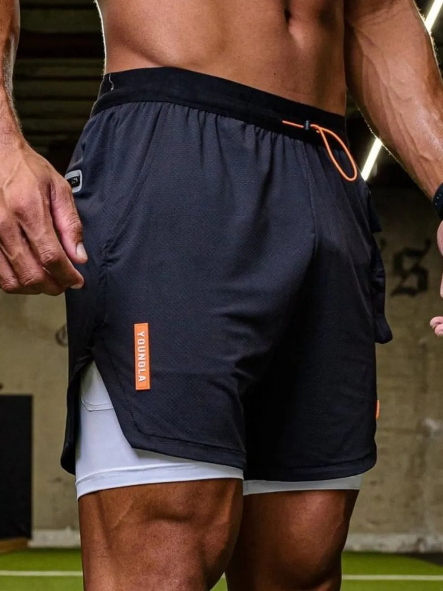 Black performance layered cargo shorts with orange accents and white inner shorts.