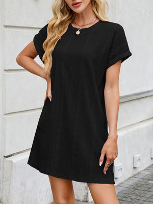 Black eyelet mini dress with crew neck, short sleeves, and diamond pattern.