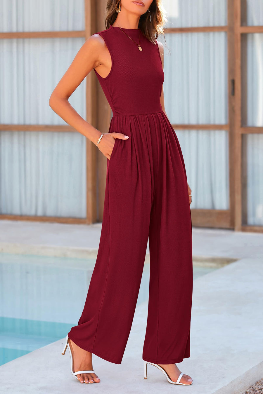 Burgundy ribbed mock neck sleeveless jumpsuit with wide legs and pockets.