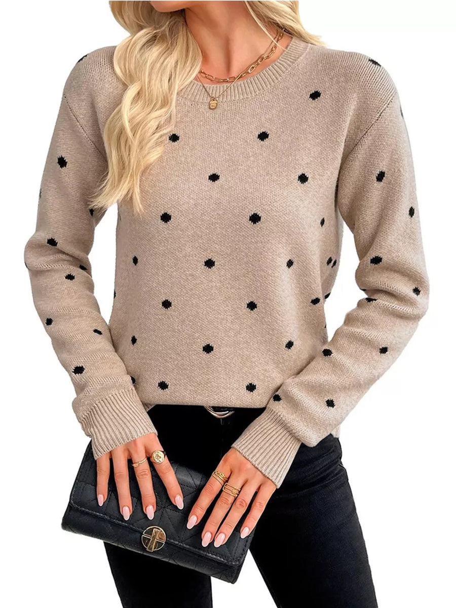 black pullover sweater featuring ribbed cuffs and polka dot