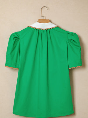 Green cotton blouse with white collar, ricrac trim, and puff sleeves.