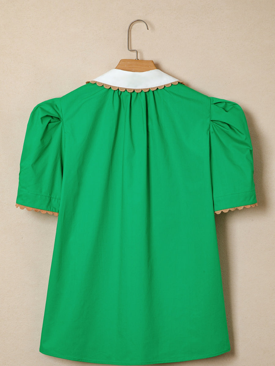 Green cotton blouse with white collar, ricrac trim, and puff sleeves.