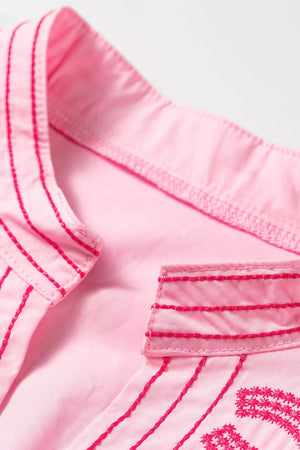 Pink cotton shirt with contrast embroidery detail on collar and placket.