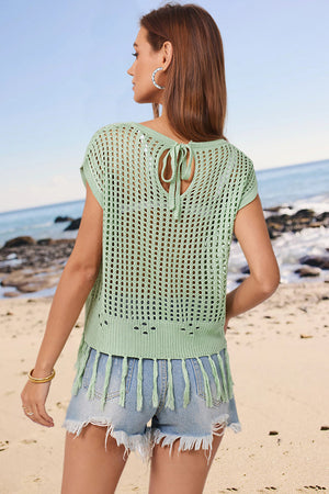 Light green open-knit cover-up with short sleeves, tie-back detail, and tassel hem.