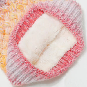 Textured ombre knit beanie with fuzzy sherpa lining in pink and yellow gradient.