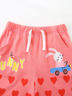 Pink cotton toddler shorts with bunny, ladybug, and heart print.