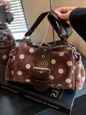 cream shoulder bag featuring adjustable strap and polka-dot