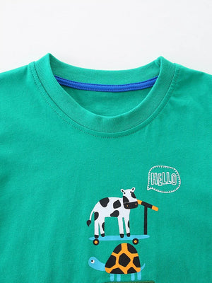 Green cotton toddler tee with cow on scooter and turtle print.